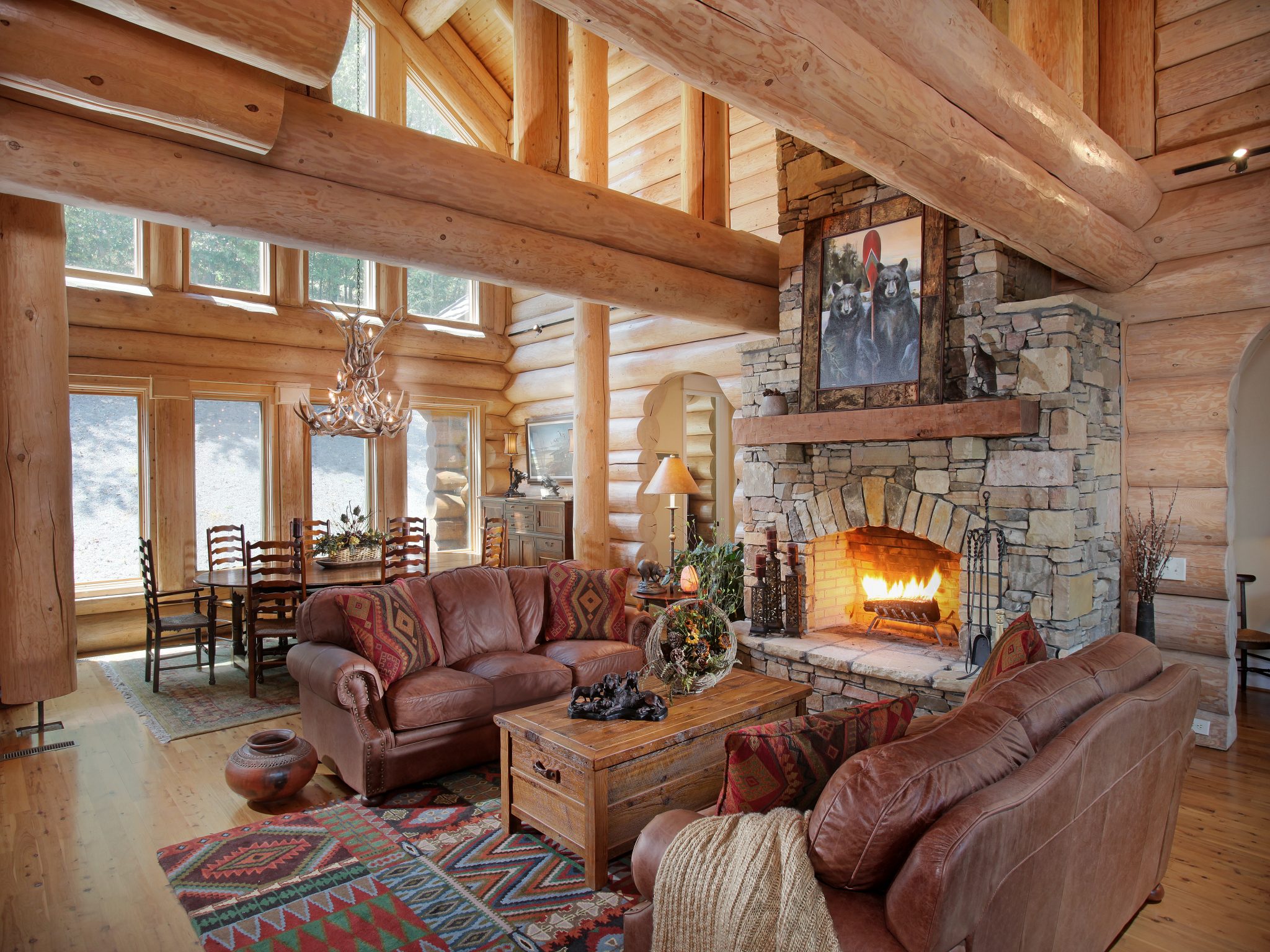 Log Home Living Room With Black Sofas