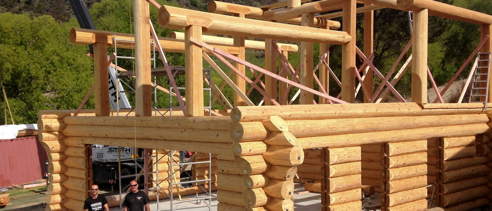 Log home builders assembling a custom log home from a North American Log Crafters Log Plan